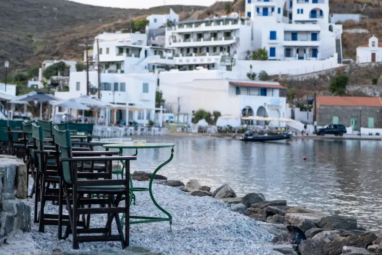 greek island outdoor cafe bar tables by sea sunny day